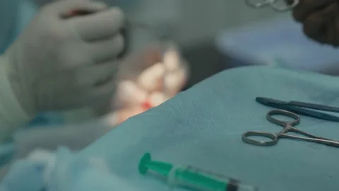 Surgical instruments, the nurse passes the instruments to the surgeon Stock Footage 130962555