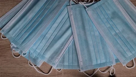 Surgical mask appears on the table Stock Footage 156104987