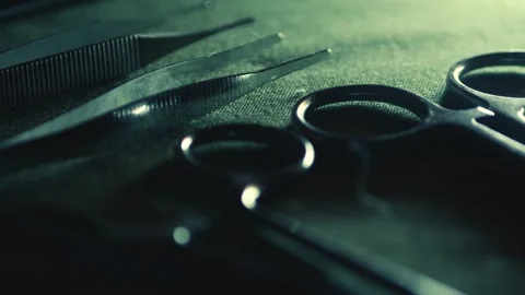Surgical medical instruments laid out on green linen. Focus reveal Stock Footage 314719341