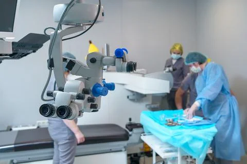 Surgical microscope in operating room with doctors. Ophthalmological clinic Stock Photos