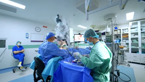 Surgical microscope in use during neurosurgery in a modern operating room Stock Footage 335759034