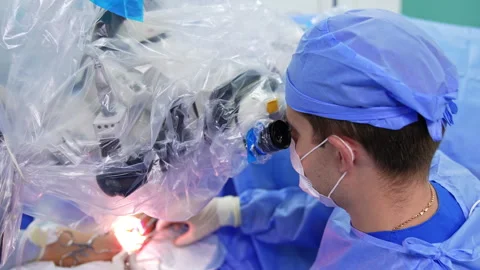 Surgical operation performed under the microscope Stock Footage 294576331