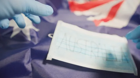 Surgical protective mask lying on a flag. Flu and Corona Virus Stock-Footage 126911497