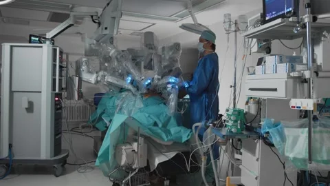 Surgical robot with multiple arms performs operation in modern operating room Stock Footage 246621912