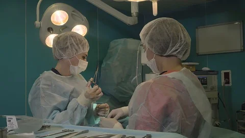 Surgical team are performing surgery on breasts in hospital operating room. Video stock 89955074
