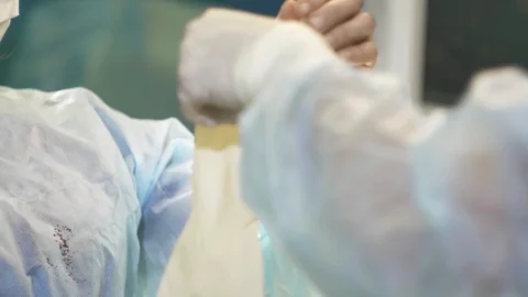 Surgical team are performing surgery on breasts in hospital operating room. Видео 89955077