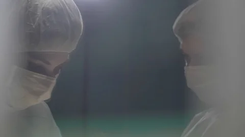 Surgical team are performing surgery on breasts in hospital operating room. Видео 89955194