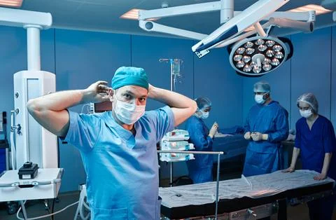 Surgical team getting ready for beginning of surgical operation in operatin.. Photos