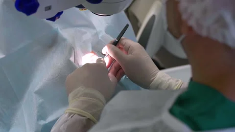 The surgical team operating on patient in the operating room. Close-up of the Stock Footage 154159421