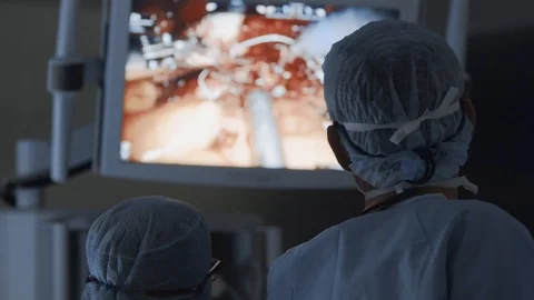 Surgical team perform complex operation via high-tech medical robotic system Stock Footage 102224583