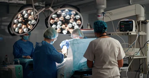 Surgical team performing complex operation in hospital setting Stock Footage 302717015
