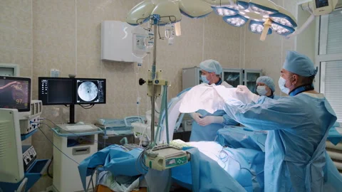 Surgical team performing operation in modern operating room Stock Footage 306165641