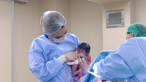 Surgical team performing surgery operation, cesarean section. Gynecologists.. Video stock 75429548