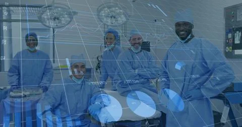Surgical team posing at OR table on cue, holographic graphs scrolling across Stock Photos