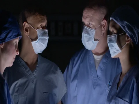 Surgical team talking together while preparing for operation 4K Stock Footage 69390748
