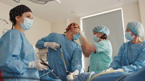 Surgical Team Working In Operating Theatre. During the operation in the Stock Footage 174214004