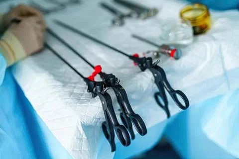 Surgical tools with forceps and scissors on medical sheet Stock Photos