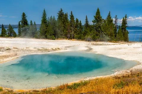 Surging Spring and Yellowstone Lake in West Thumb Geyser Basin Stock Photos
