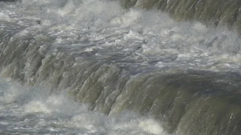 Surging waters in a swollen river after a torrential rain Stock Footage 287755663