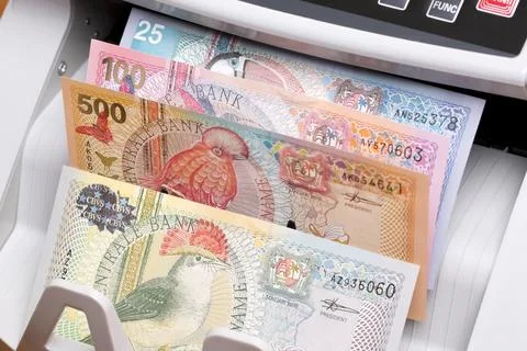 Surinamese dollar in the counting machine Stock Photos