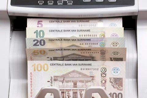 Surinamese dollar in the counting machine Stock Photos