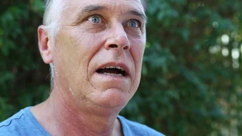 Surprise! Cheerful man's face transforms into a look of amazement Video stock 183357025