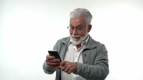 Surprise, happiness. Elderly man pose with smartphone, read received sms with Stock Footage 221774818