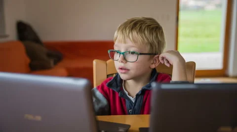 Surprise look on kid face looking at computer Stock Footage