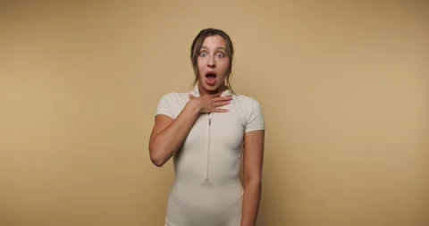 Surprise reactions during an expressive performance on a plain background Stock Footage 317395678