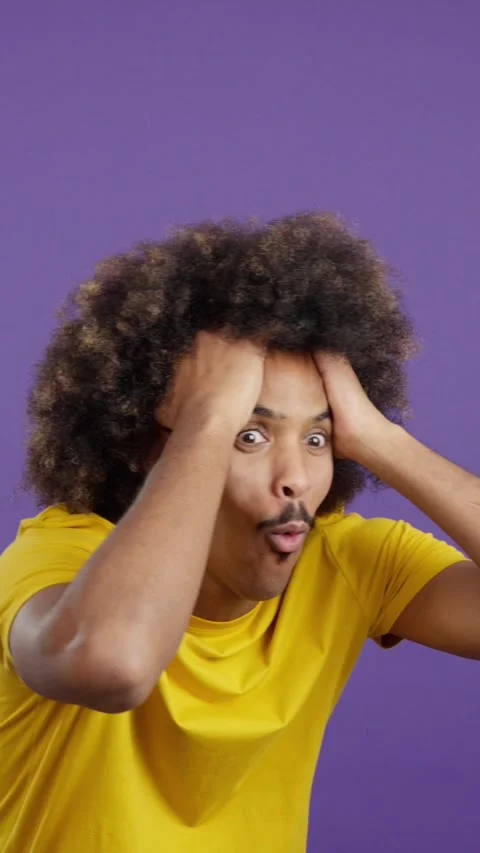 Surprised african man looking at the camera gesturing Stock Footage 241198822