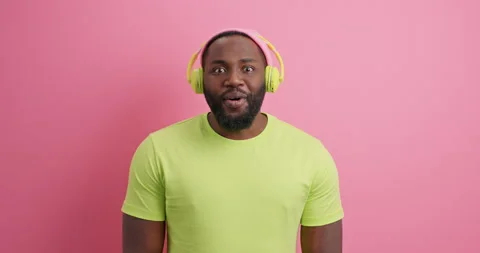 Surprised Afro American guy says wow cannot believe his eyes wears casual t Stock Footage 151196570