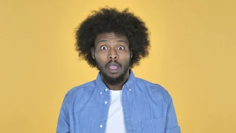 Surprised Afro-American Man in Shock on Yellow Background, wondering Stock Footage 99219865