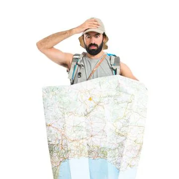 Surprised backpacker with map over white background Fotos Stock