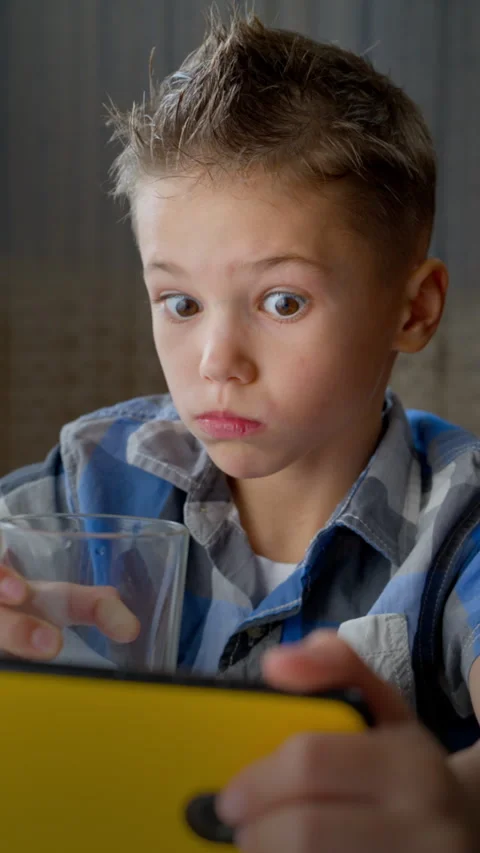 Surprised Boy Looking at Smartphone Screen with Wide Eyes Stock Footage 320635790