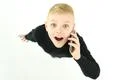 The surprised boy phone on the white background. View from above Photo