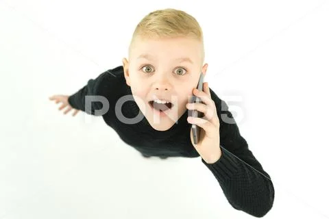The surprised boy phone on the white background. View from above Stock Photos