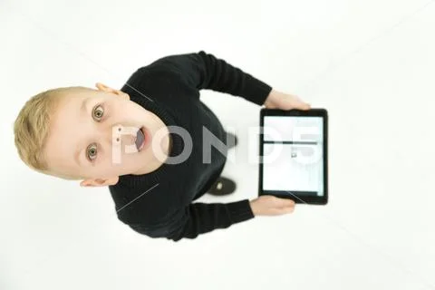 The surprised boy stand with a laptop. View from above Stock Photos