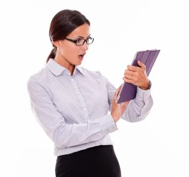 Surprised businesswoman using a tablet while looking at the tablet with her m Stock Photos