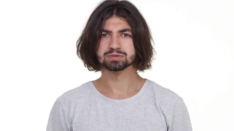 Surprised Caucasian guy incredulously looking at camera isolated over white Stock Footage
