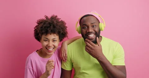 Surprised cheerful dark skinned girlfriend and boyfriend have fun together have Stock Footage 149916577