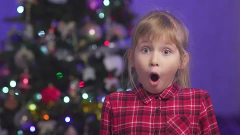 Surprised child against the background of blurry lights Stock Footage 146367234