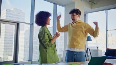 Surprised colleagues rejoicing win looking laptop at design workshop closeup. Stock Footage 318795639