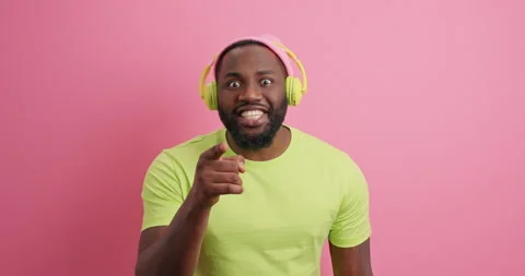Surprised dark skinned man says wow and points directly at camera sees something Stock Footage 151622414