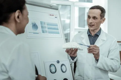 Surprised doctor expressively explaining brain inside structure 스톡 사진