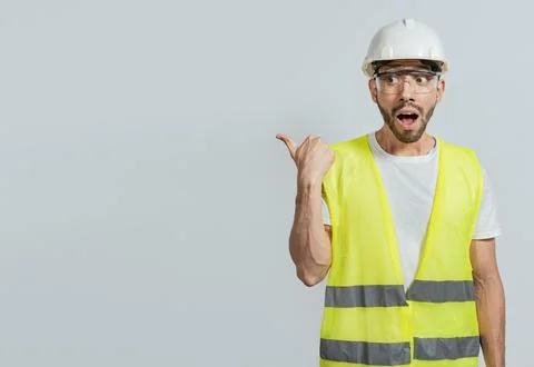 Surprised engineer pointing to the side. Surprised face construction worker.. Stock Photos