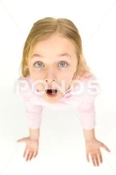 The surprised girl look to the camera. View from above Stock Photos