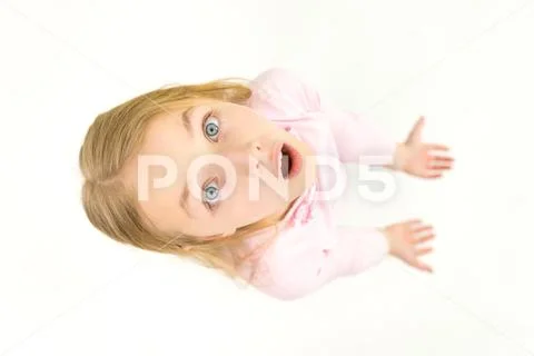 The surprised girl look to the camera. View from above Stock Photos