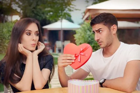 Surprised Girl Receiving Heart Shaped Gift from her Boyfriend Stock Photos