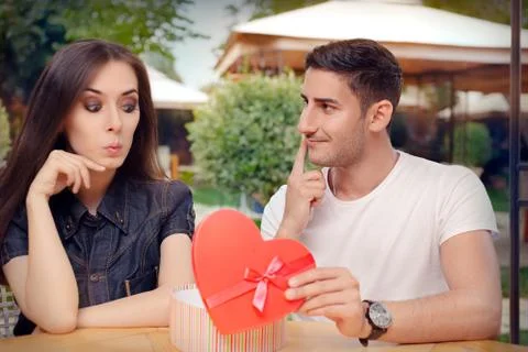 Surprised Girl Receiving Heart Shaped Gift from her Boyfriend Stock Photos