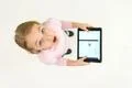 The surprised girl stand with a tablet. View from above Photo